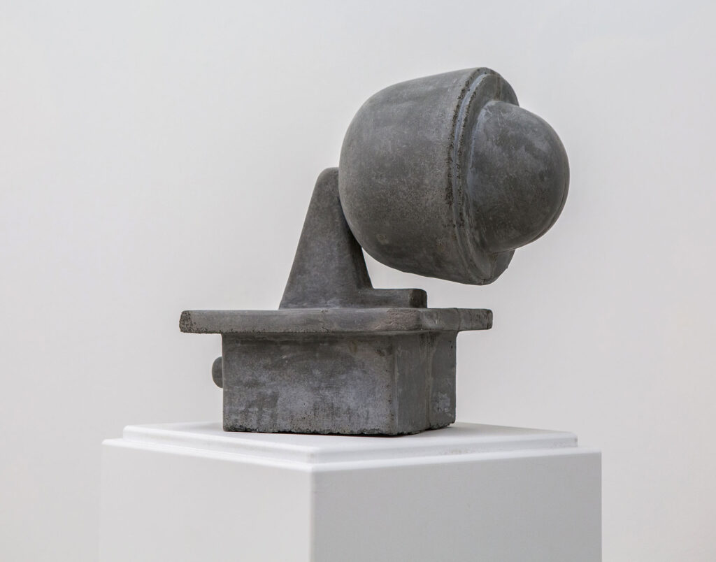 A concrete sculpture of a police surveillance camera