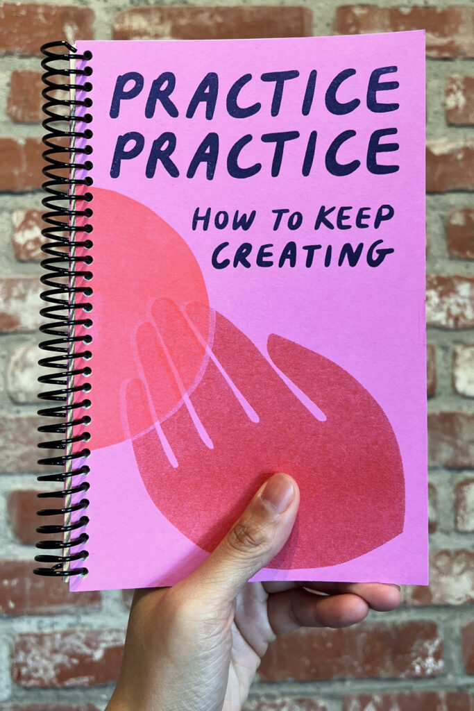 A hand holding a copy of Practice Practice: How to Keep Creating by Dylan Cale Jones and Isa Rodriguez